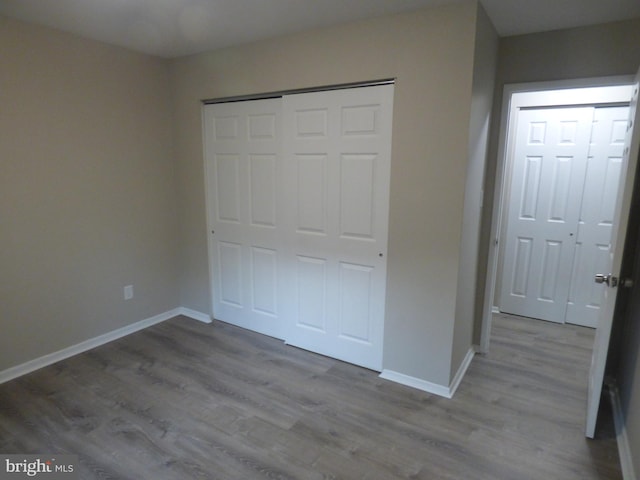 unfurnished bedroom featuring a closet and light hardwood / wood-style flooring