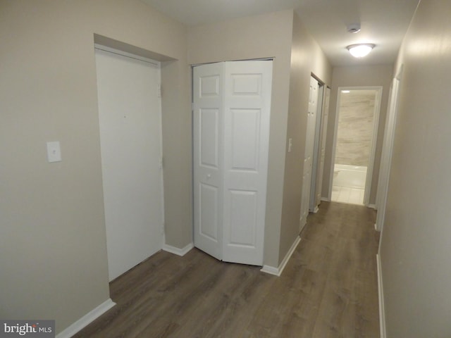 hall with dark hardwood / wood-style flooring