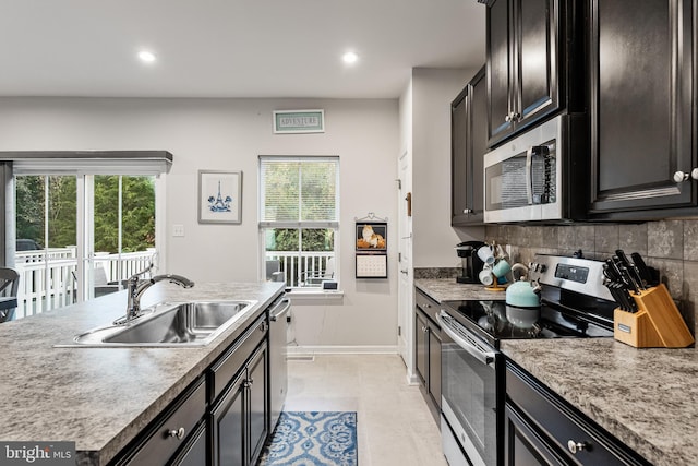 kitchen featuring tasteful backsplash, sink, and stainless steel appliances