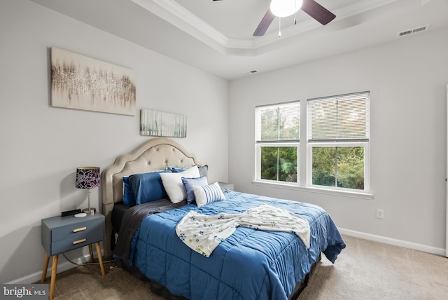 bedroom with carpet, a raised ceiling, ceiling fan, and crown molding