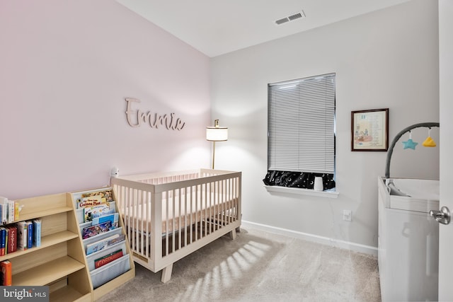 carpeted bedroom with a nursery area