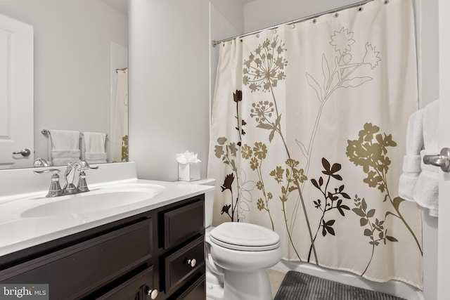 bathroom featuring toilet, vanity, and tile patterned floors