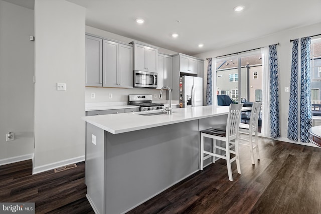 8510 Randell Ridge Rd, Frederick, MD 21704 - kitchen with stainless steel appliances, a sink, dark wood-type flooring, an island with sink, and a kitchen bar