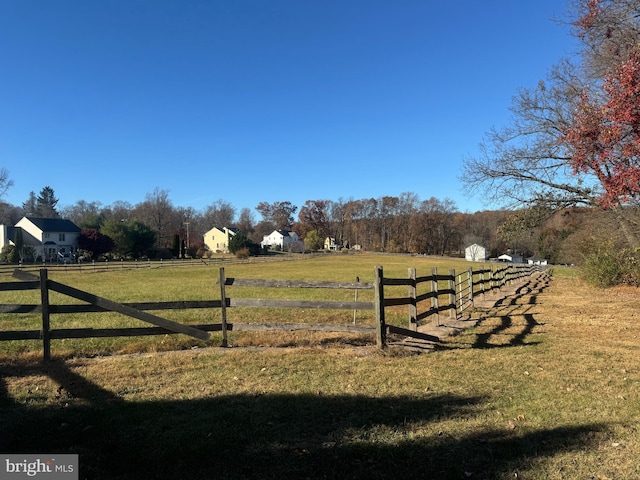 exterior space featuring a rural view and a lawn