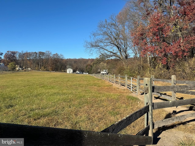 view of yard with a rural view