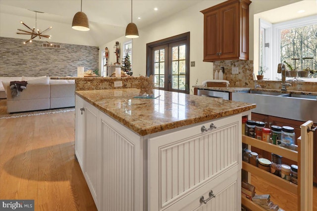 kitchen featuring a wealth of natural light, french doors, a kitchen island, and pendant lighting