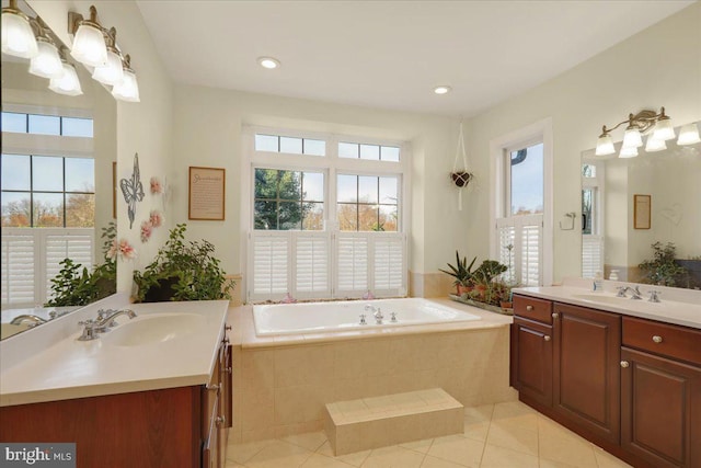 bathroom featuring tiled tub, tile patterned flooring, and vanity