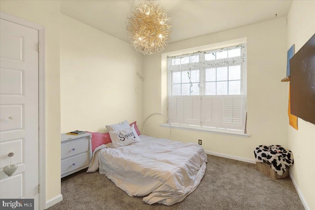 bedroom featuring carpet floors and an inviting chandelier