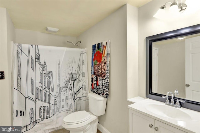 bathroom featuring a shower, vanity, and toilet