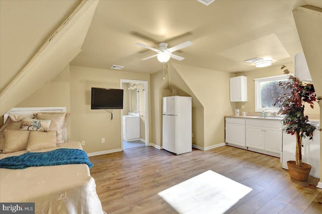 bedroom with ensuite bathroom, ceiling fan, sink, light hardwood / wood-style flooring, and white fridge