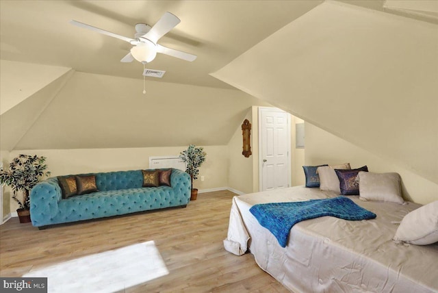 bedroom with ceiling fan, wood-type flooring, and lofted ceiling