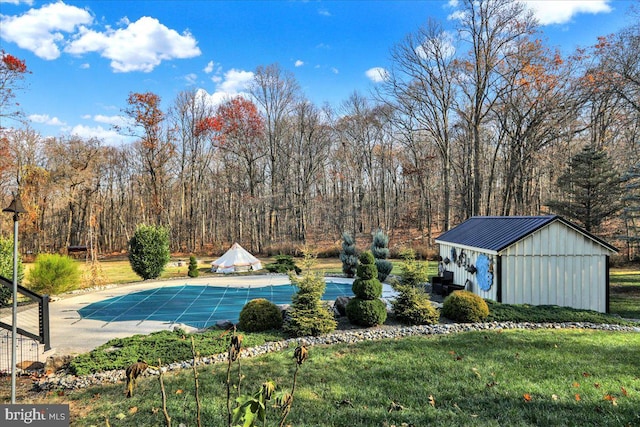 view of swimming pool with an outbuilding