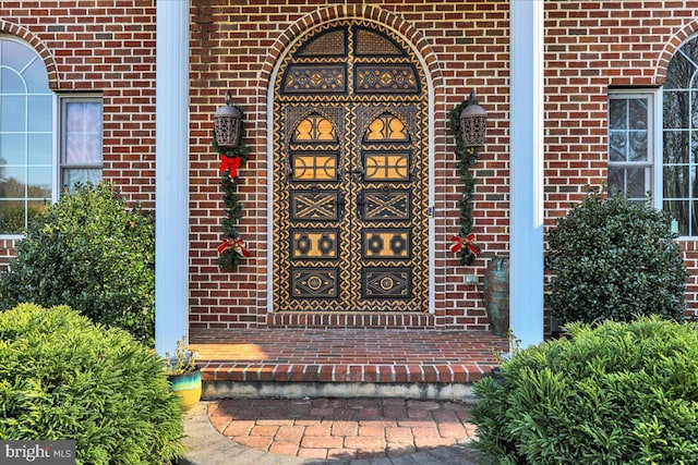 property entrance with brick siding