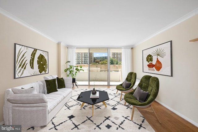 living room with ornamental molding and light hardwood / wood-style floors