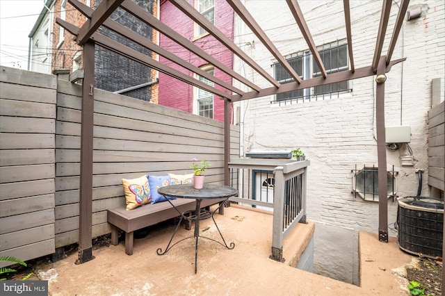 view of patio with central air condition unit and a pergola