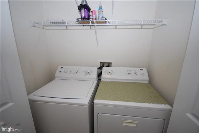 clothes washing area featuring independent washer and dryer