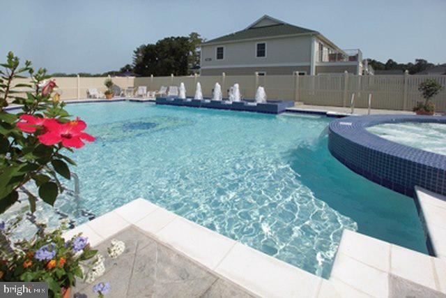 view of pool with an in ground hot tub