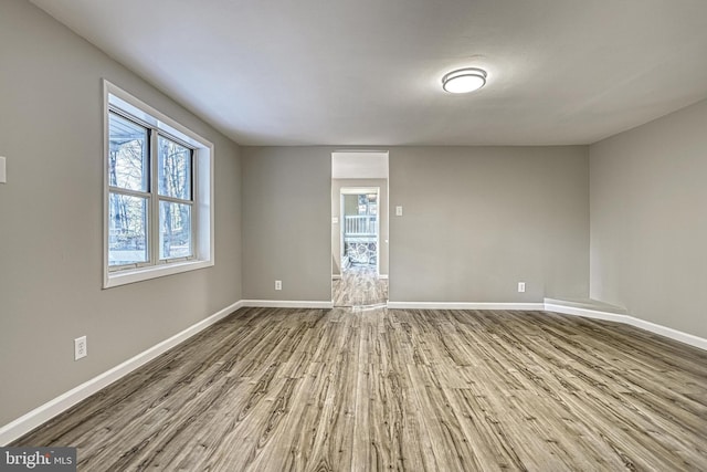 unfurnished room with hardwood / wood-style flooring