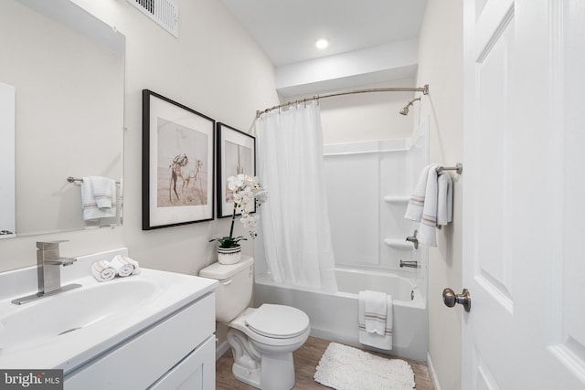 full bathroom featuring hardwood / wood-style flooring, vanity, toilet, and shower / bath combination with curtain