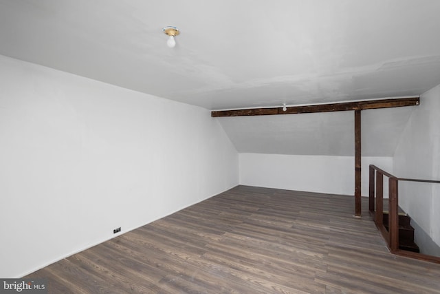 bonus room featuring vaulted ceiling with beams and dark hardwood / wood-style floors