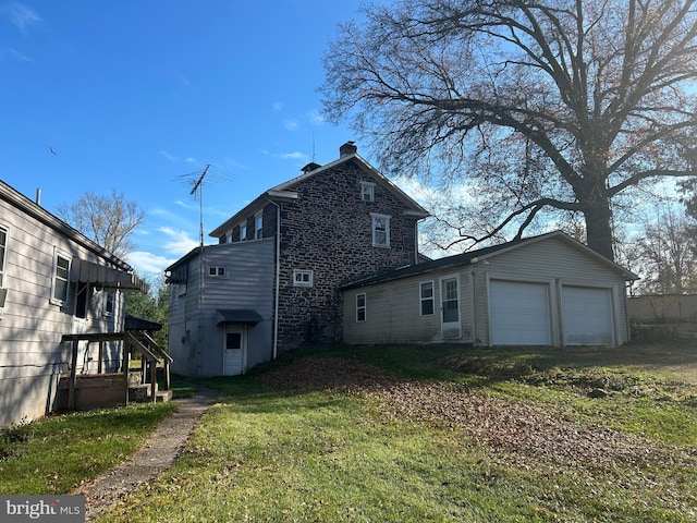 rear view of house featuring a lawn