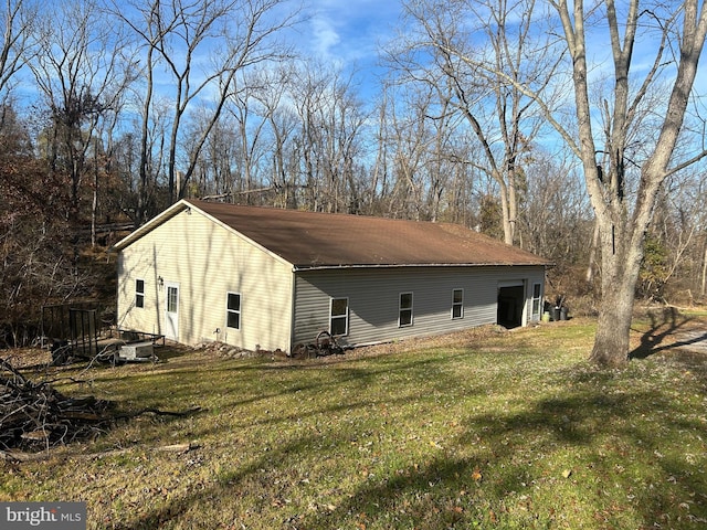 view of side of home with a yard