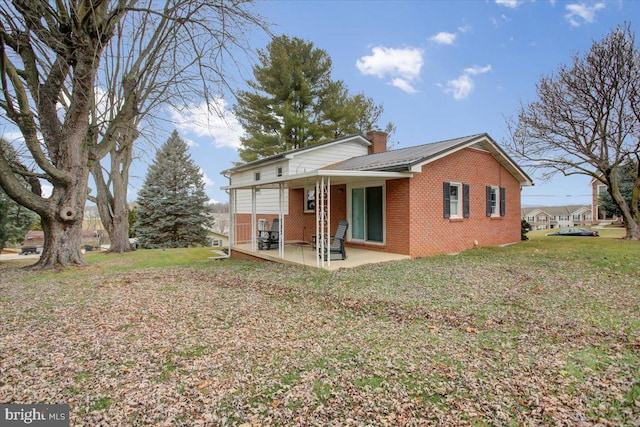 back of property featuring a yard and a patio