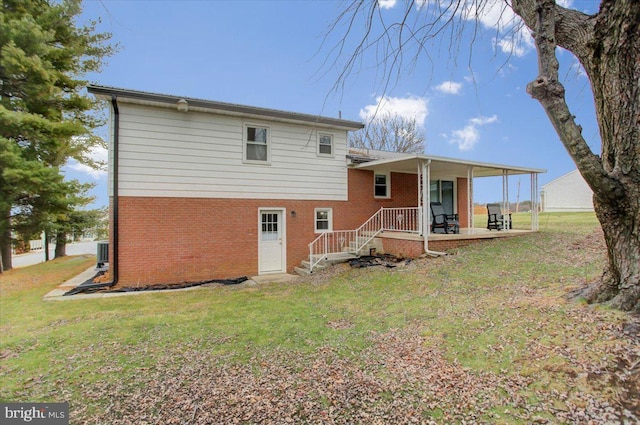 rear view of property with a lawn