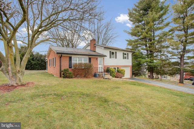 view of front of property with a garage and a front yard