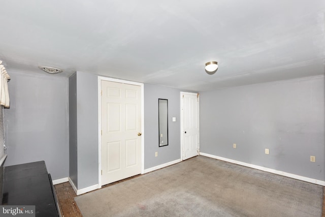 unfurnished bedroom featuring dark carpet