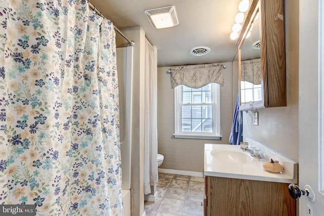 bathroom featuring tile patterned flooring, vanity, toilet, and curtained shower