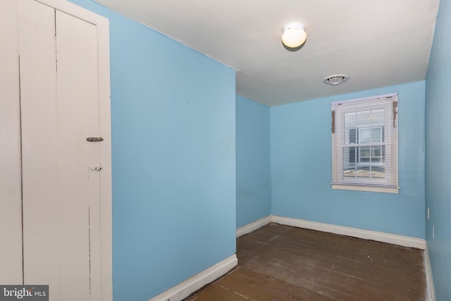 additional living space featuring dark wood-type flooring