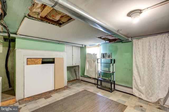 basement featuring a baseboard heating unit