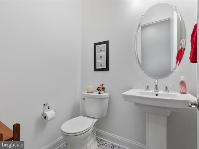 bathroom with tile patterned floors, toilet, and sink