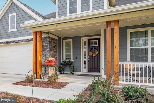 property entrance featuring covered porch and a garage