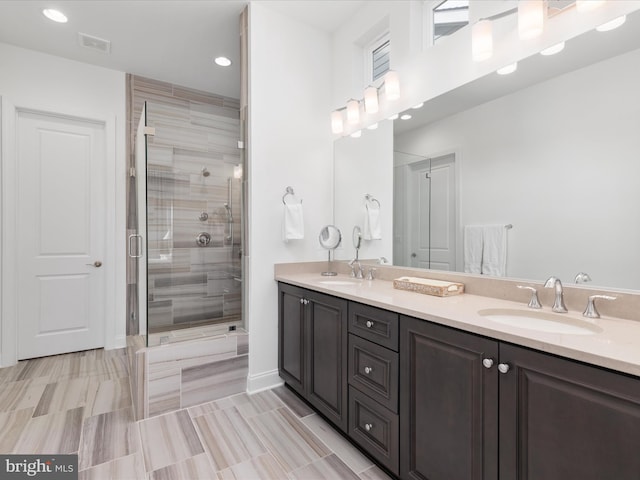 bathroom with vanity and a shower with shower door