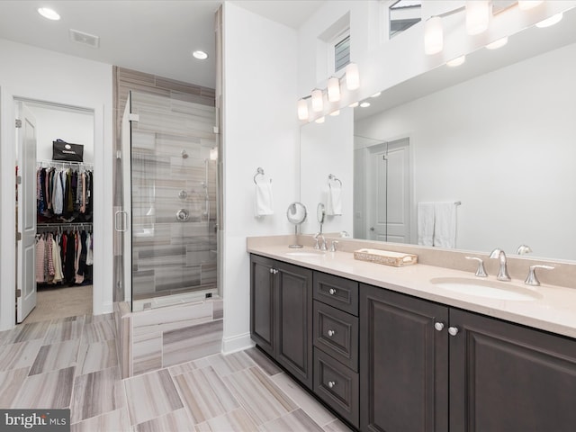 bathroom with vanity and a shower with shower door