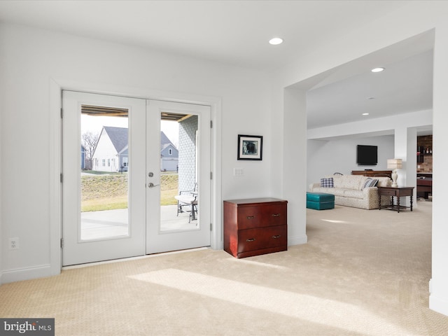 entryway with light carpet and french doors