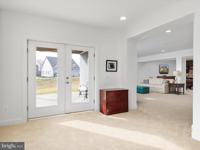 doorway featuring light carpet and french doors