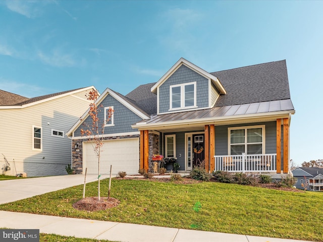 craftsman house with a porch, a garage, and a front yard