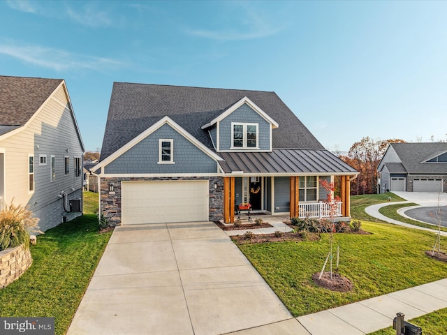 view of front of house with a porch, a garage, and a front yard