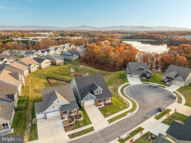 birds eye view of property featuring a water and mountain view