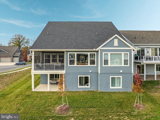 rear view of house featuring a patio area and a yard