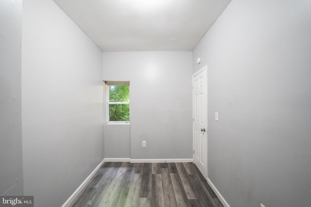 unfurnished room featuring dark wood-type flooring