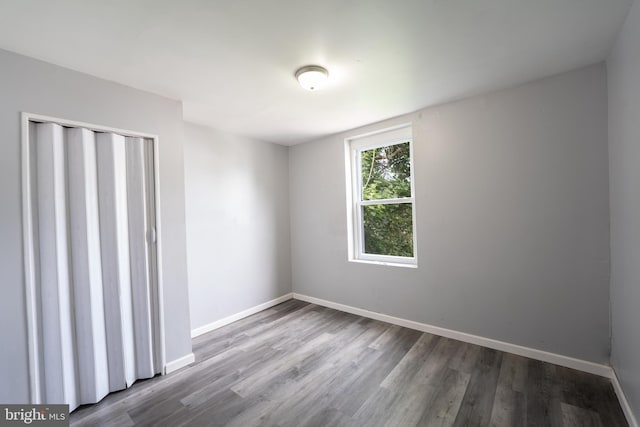 unfurnished room with wood-type flooring