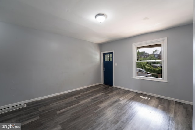 spare room with dark hardwood / wood-style floors