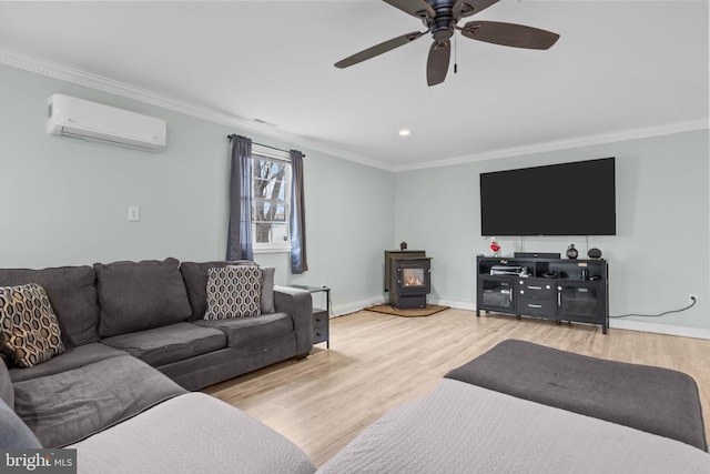 living area featuring a wall unit AC, a wood stove, ornamental molding, and light wood-style floors