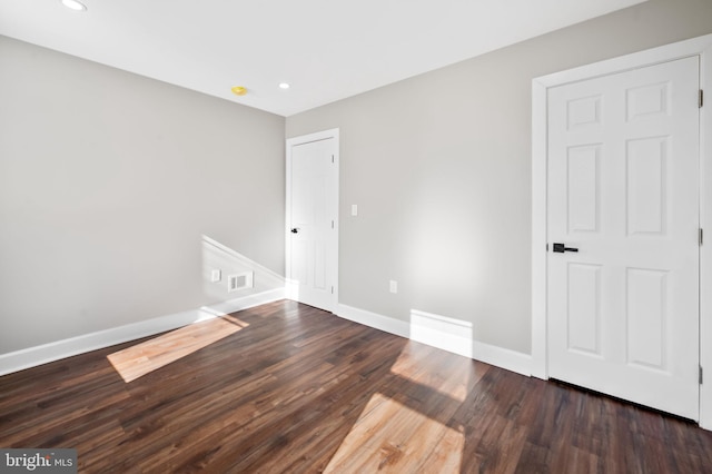 unfurnished room featuring dark hardwood / wood-style floors