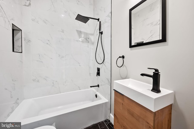 bathroom featuring tiled shower / bath combo and vanity