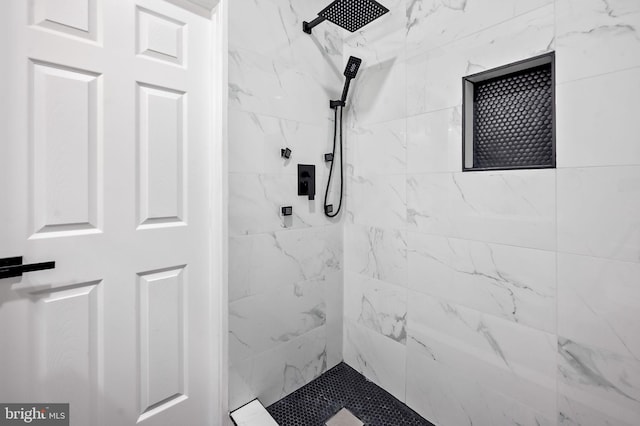 bathroom with tiled shower